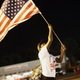 A demonstrator protesting the shooting of Michael Brown waves the American flag Aug. 21, 2014, in Ferguson, Mo.
Joshua LOTT/AFP/Getty Images